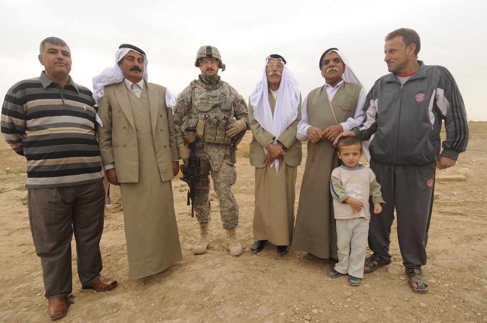 Soldiers inspect wells, visit children