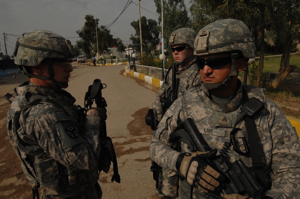 U.S. troops work with Iraqi police