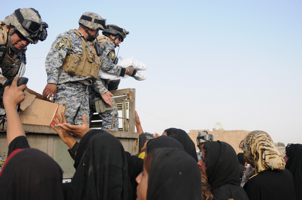 Soldiers give clothes, toys to local Iraqis
