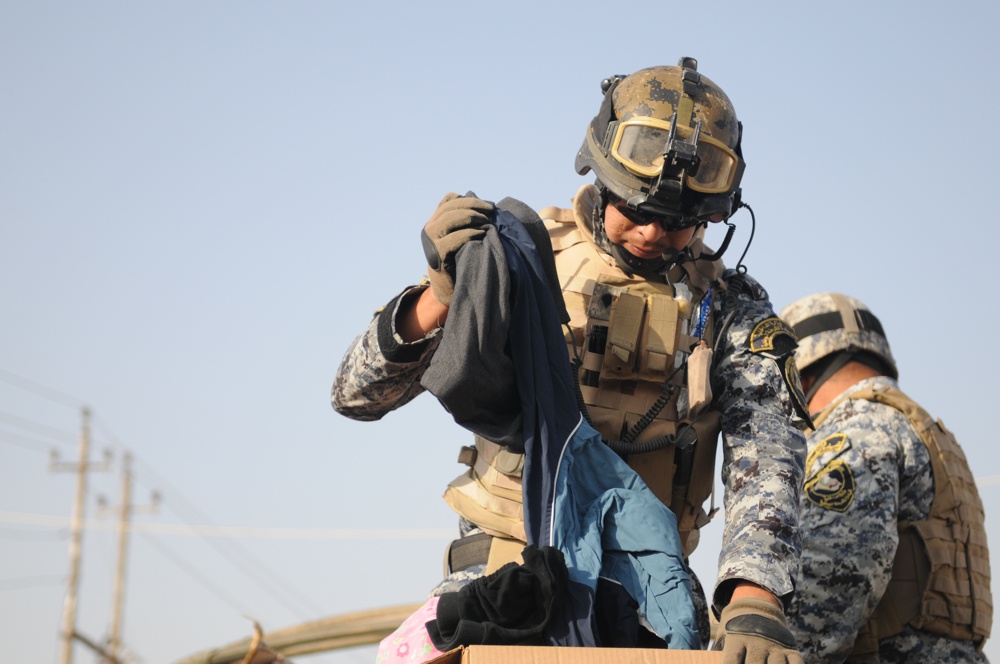 Soldiers give clothes, toys to local Iraqis