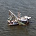 US Coast Guard Small Boat Assists Man With Leg Injury