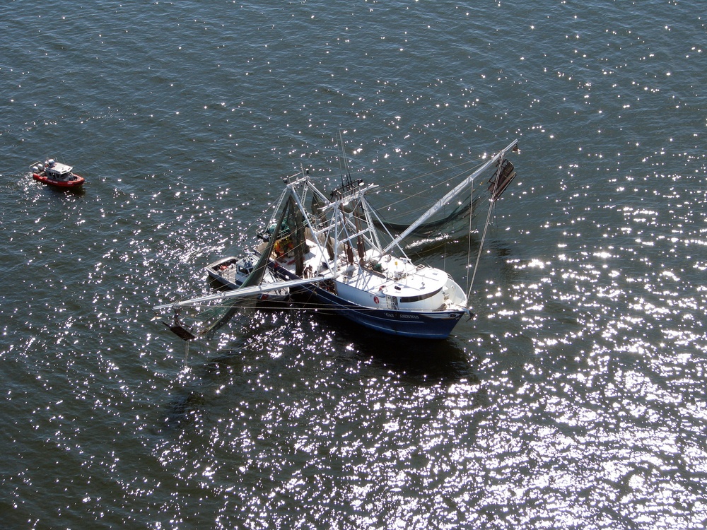 US Coast Guard Small Boat Assists Man With Leg Injury