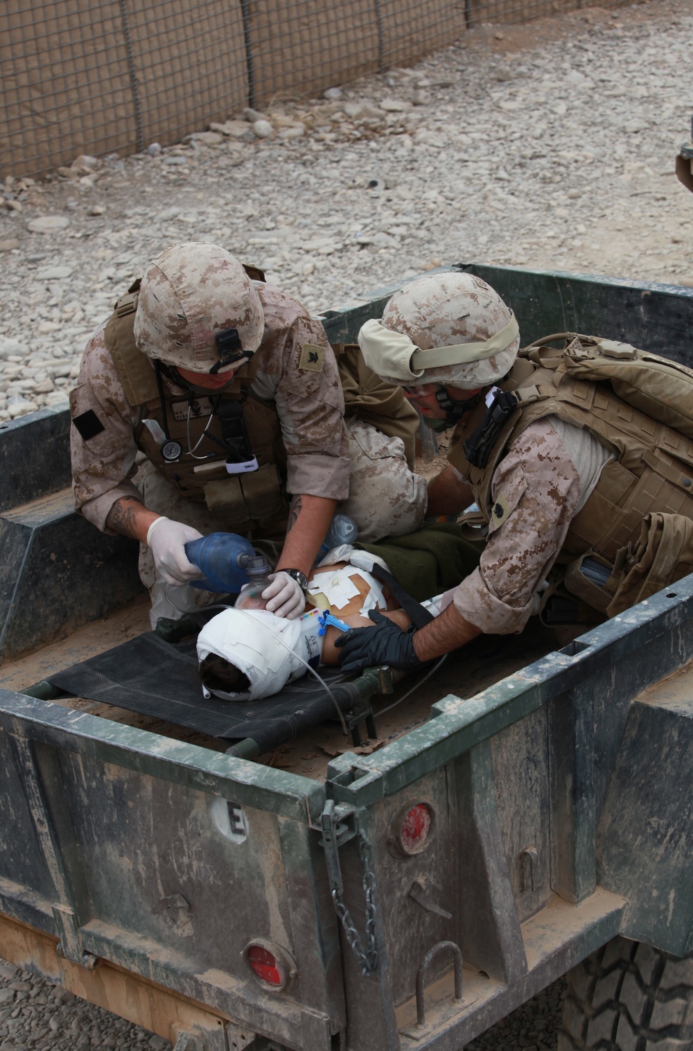 Corpsmen care for wounded boy