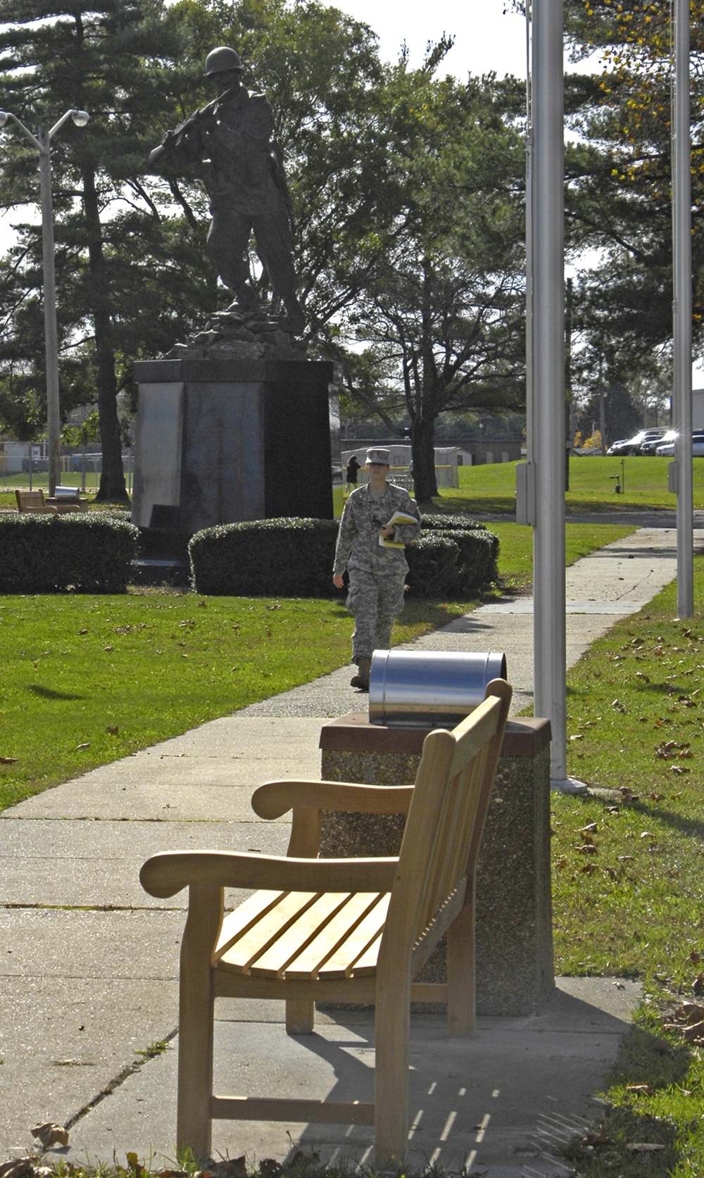 Soldiers walks past Ultimate Weapon statue