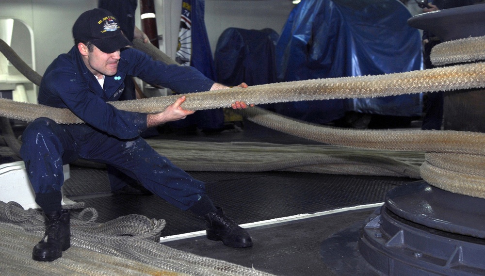 Sailors handle mooring lines