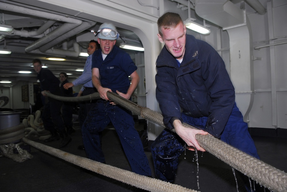 Sailors handle mooring lines