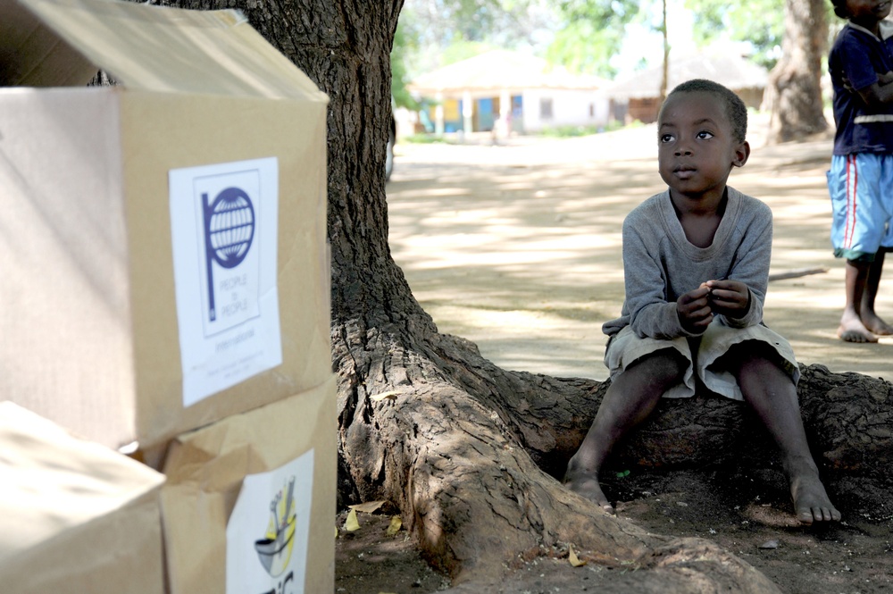 CJTF-HOA service members give supplies to African locals