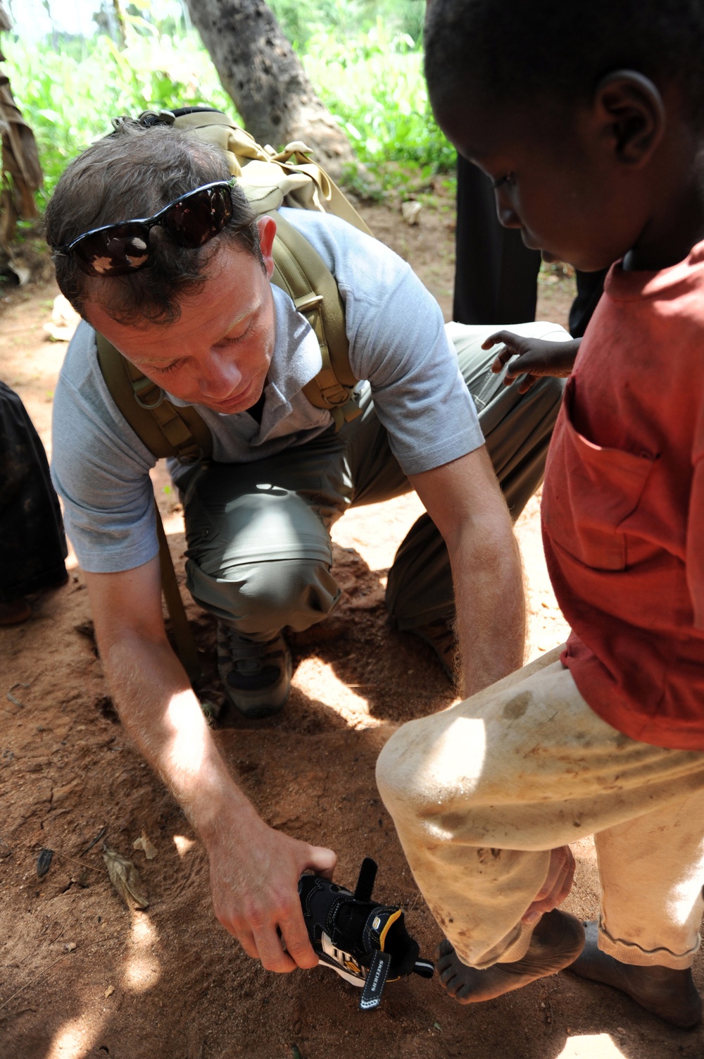 CJTF-HOA service members give supplies to African locals