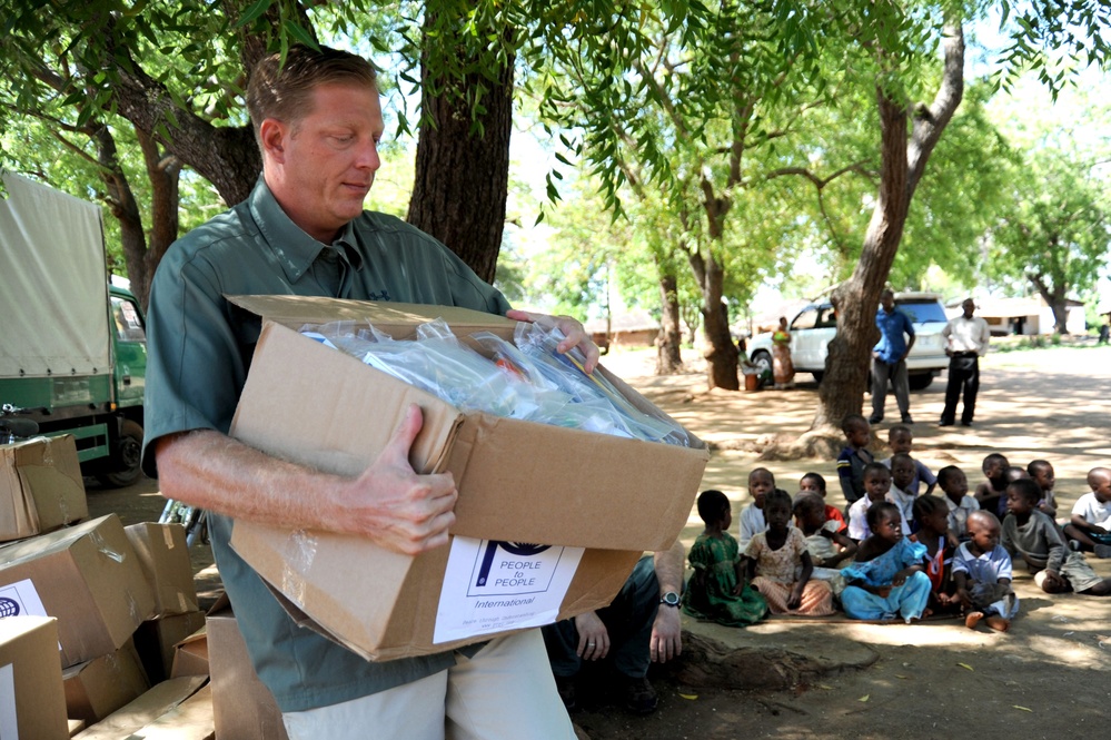 CJTF-HOA service members give supplies to African locals