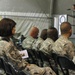 Chief Master Sgt. Stephanie Cardozo with Joint Task Force MED east/455th Expeditionary Medical Group, listens to Army Sgt. First Class Raleigh Sell, the protocol non-commissioned officer in charge from Combined Joint Task Force 82. Sell spoke at the Veter