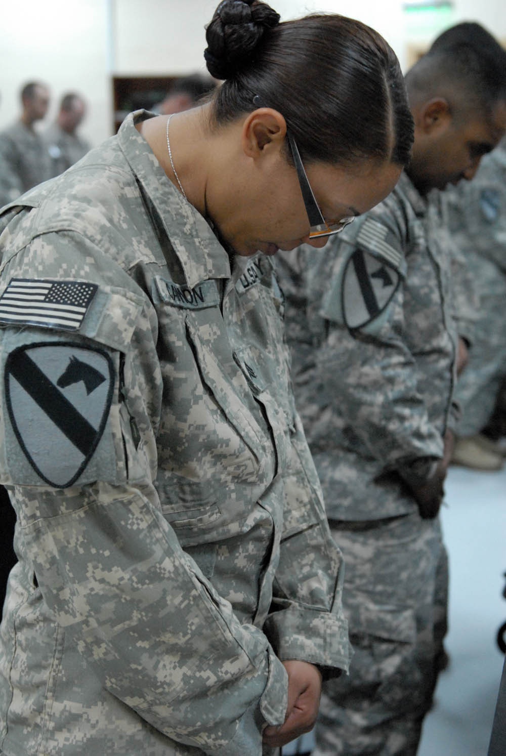 Chicago native, Sgt. Jessica Cannon with 115th Brigade Support Battalion, 1st Brigade Combat Team, 1st Cavalry Division, bows her head during the prayer at the Veteran's Memorial Day service at Camp Taji, Nov. 12.