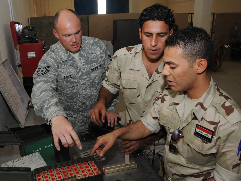U.S. Airmen Unload Ammunition Skills on Iraqis