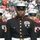 New York Jets Vs Jacksonville Jaguars Military Ceremony Three United States Marines in dress blue uniforms are standing in formation at what appears to be a sporting event or public ceremony. The central Marine is in sharp focus and displays multiple service ribbons and medals on his chest. A large crowd of spectators is visible in the blurred background.
