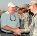 Governor Sonny Perdue, of Georgia, shakes hands with military members from the Army and Air Force during his tour, Nov. 11. The governors of Georgia, Mississippi, Wyoming and Oregon toured various bases throughout the area of responsibility on Veterans Da