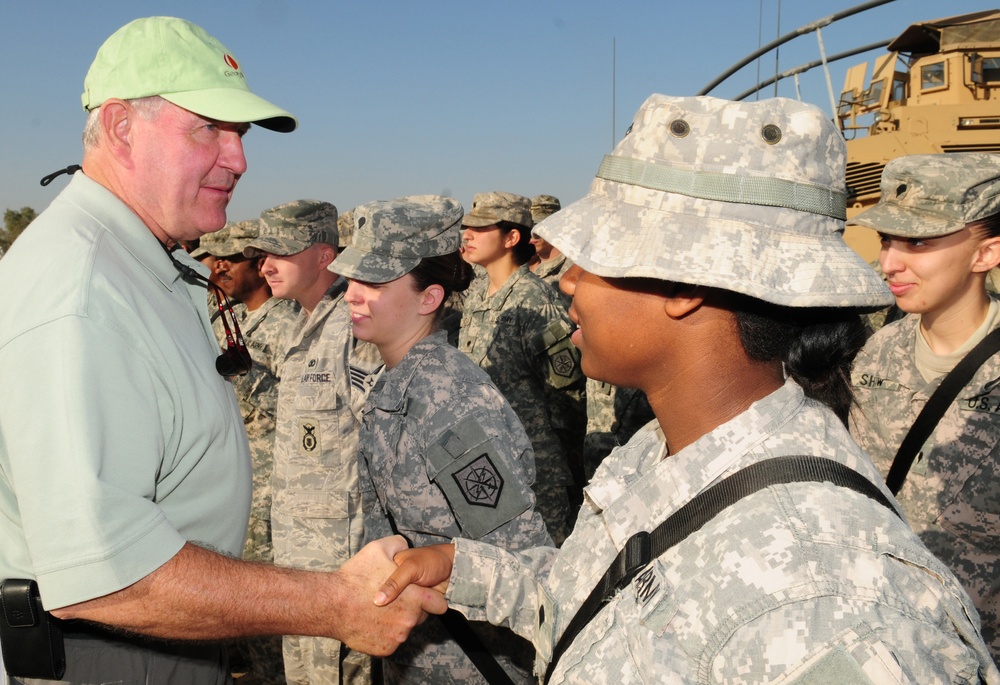 Gov. Sonny Perdue, of Georgia, shakes hands with military members from the Army and Air Force during his tour Nov. 11. The governors of Georgia, Mississippi, Wyoming and Oregon toured various bases throughout the area of responsibility on Veterans Day, sh