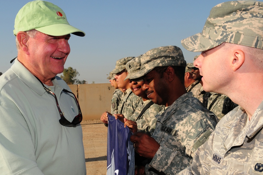 Gov. Sonny Perdue, of Georgia, shakes hands with military members from the Army and Air Force during his tour Nov. 11. The governors of Georgia, Mississippi, Wyoming and Oregon toured various bases throughout the area of responsibility on Veterans Day, sh