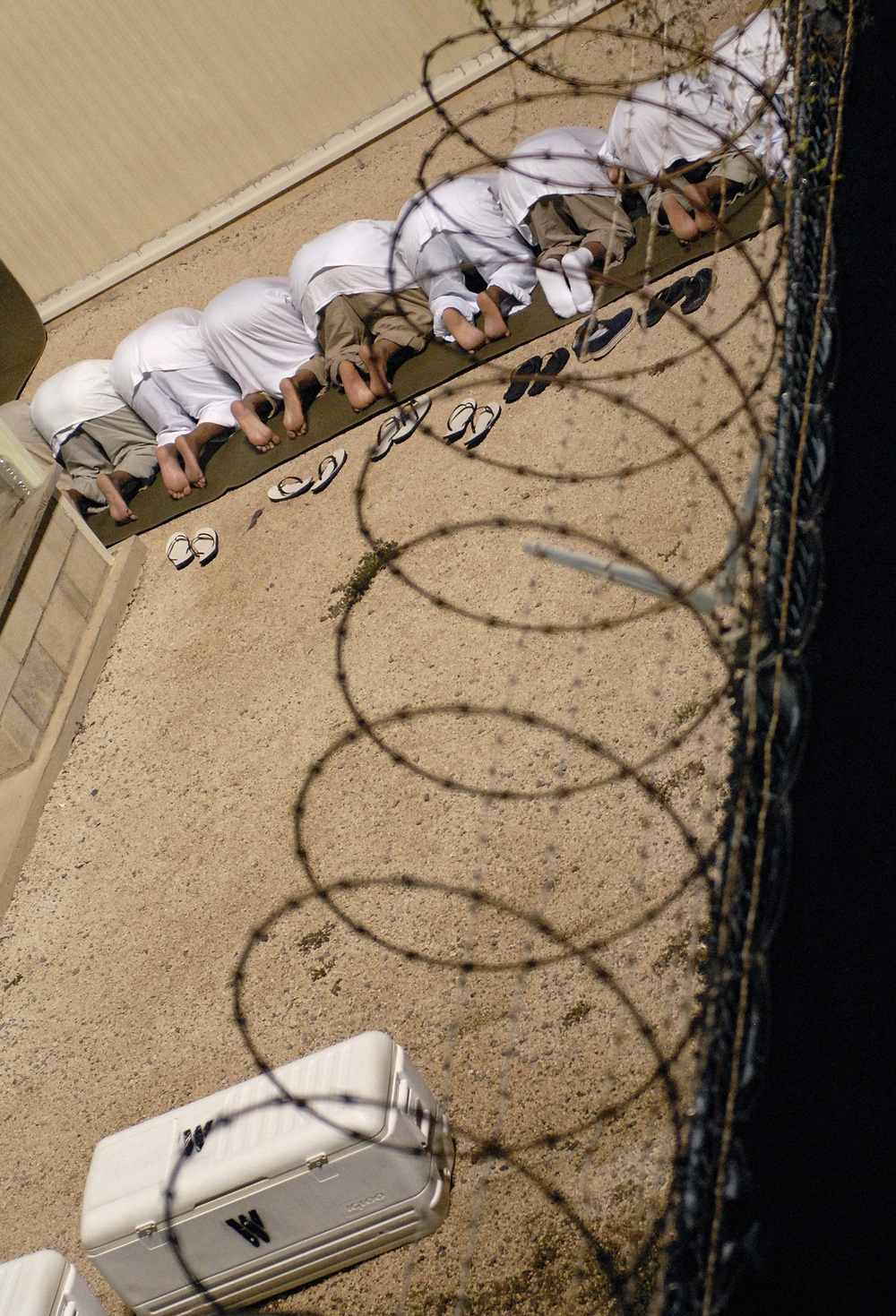 JTF Guantanamo Detainees Bow During Morning Prayer
