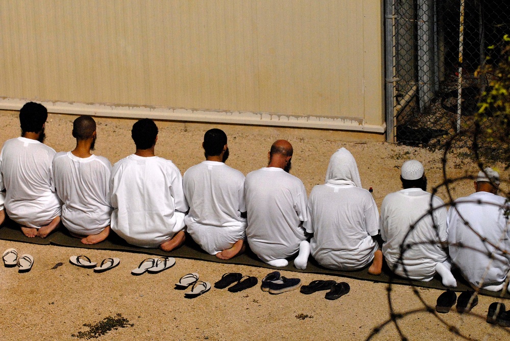 JTF Guantanamo Detainees Kneel As They Observe Morning Prayer