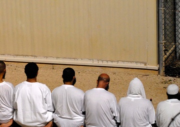 JTF Guantanamo Detainees Kneel As They Observe Morning Prayer