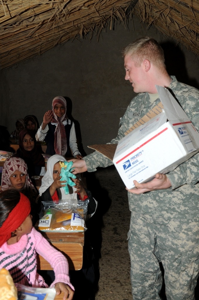 Soldiers deliver supplies, view new school building