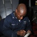 Boatswain's mate performs maintenance on line stopper