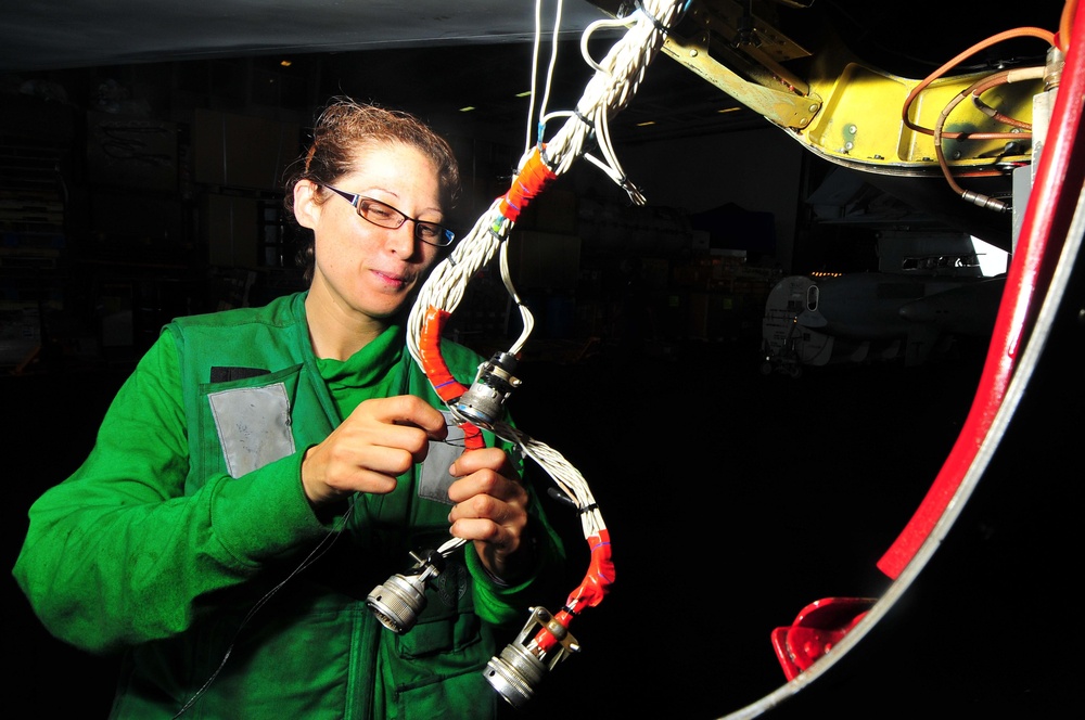 Electronics Technician spot ties wiring of EA-6B Prowler