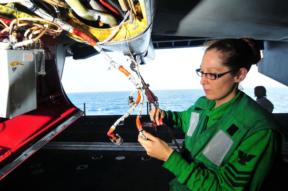 Electronics Technician spot ties wiring of EA-6B Prowler