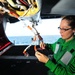 Electronics Technician spot ties wiring of EA-6B Prowler
