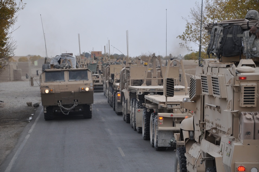 Soldiers convoy building materials, support forward operating base expansion