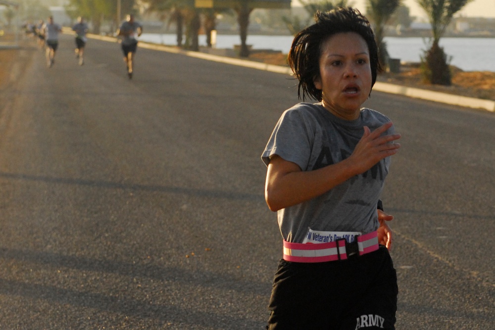 Chief Warrant Officer 2 Olga Elliot keeps a good distance in front of other racers during the 5 kilometer Veteran's of Foreign Wars Veterans Day Run Nov. 8, at Camp Victory in Baghdad. Elliott was the top female runner in the race, sprinting past the fini