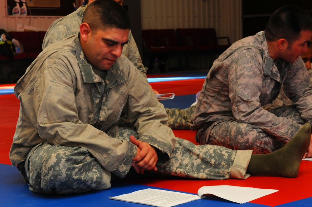 Soldier Studies Material During Combatives Course