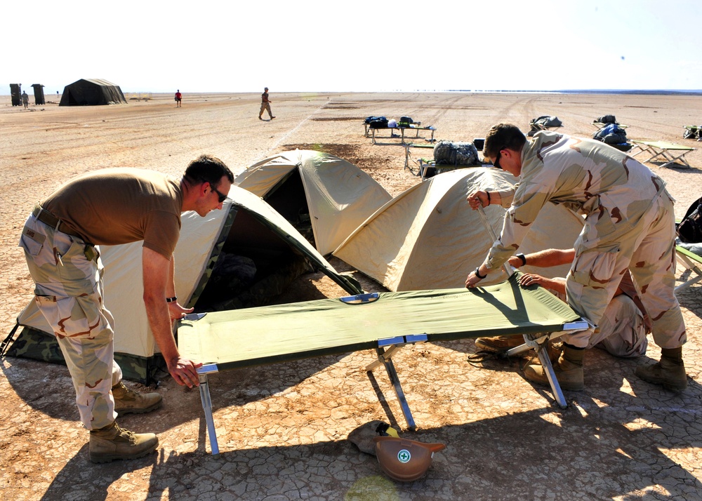 Sailors run through desert