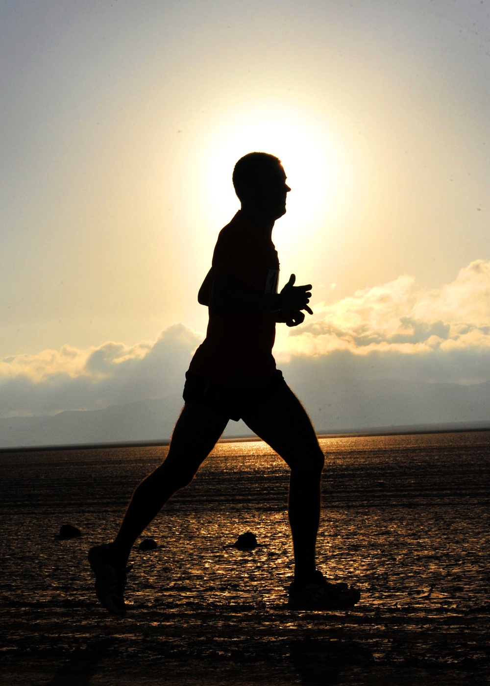Sailors run through desert