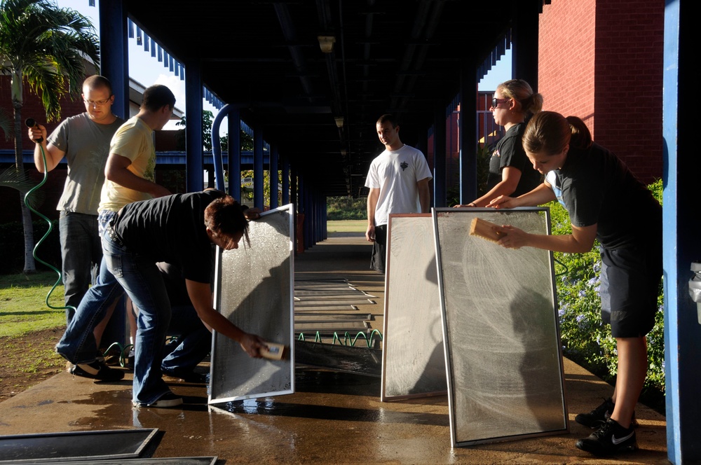 U.S. Navy and Air Force service members join in community project