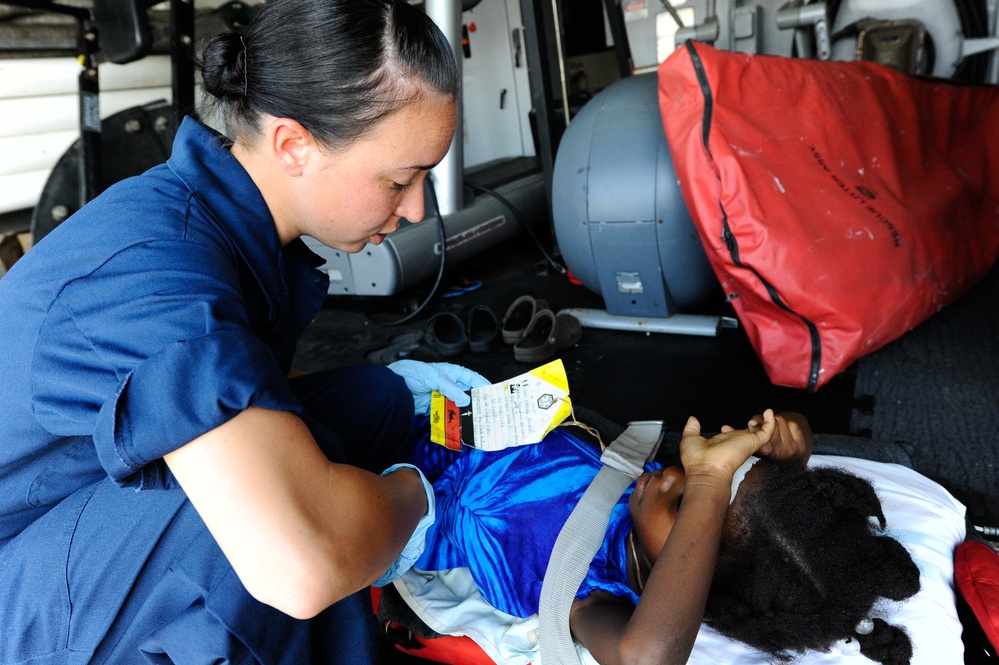 U.S. Coast Guard Member Assist Injured Haitian Girl