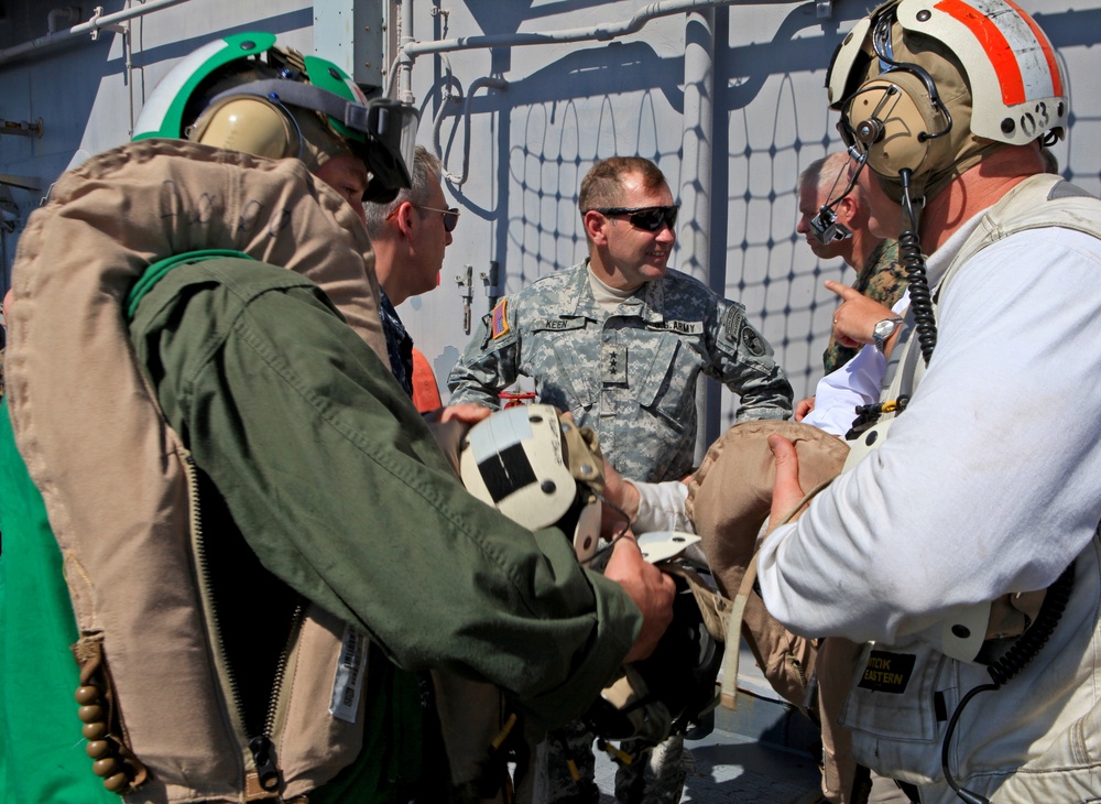 Sailors of USS Bataan stand-by as Lt. General Ken Keen, Joint Task Force Haiti commander, arrives