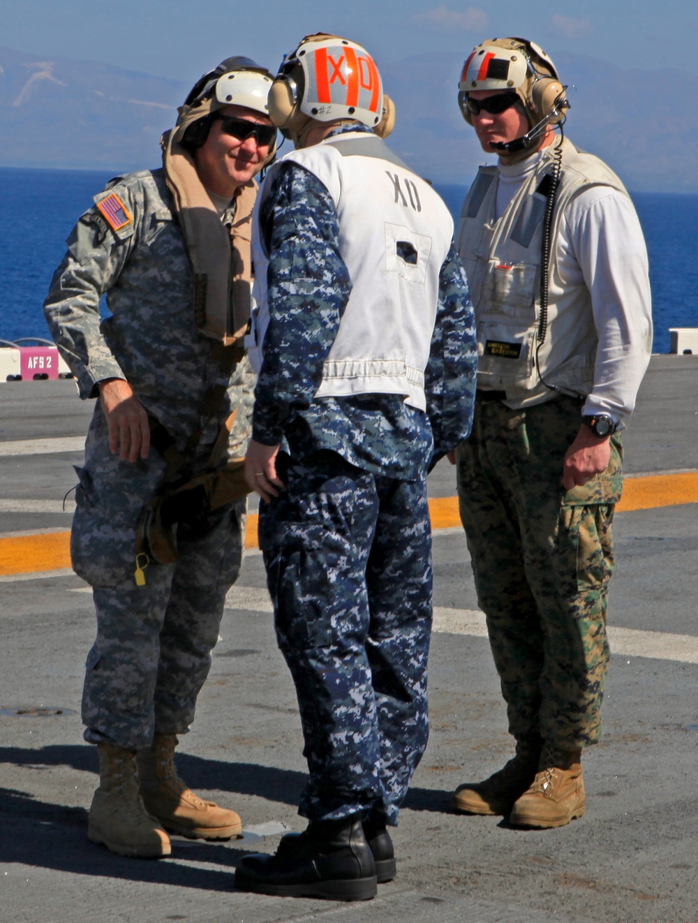 Sailors of USS Bataan stand-by as Lt. General Ken Keen, Joint Task Force Haiti commander, arrives