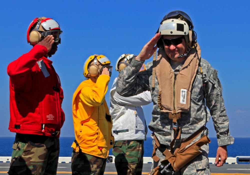 Sailors of USS Bataan stand-by as Lt. General Ken Keen, Joint Task Force Haiti commander, arrives