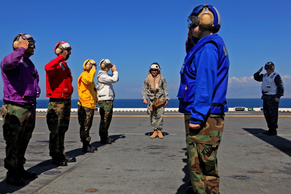 Sailors of USS Bataan stand-by as Lt. General Ken Keen, Joint Task Force Haiti commander, arrives