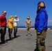 Sailors of USS Bataan stand-by as Lt. General Ken Keen, Joint Task Force Haiti commander, arrives