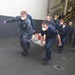 Sailors aboard USS Bataan, attend to a Haitian woman and child during a casualty evacuation