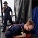 Sailor performs maintenance on submarine outer deck