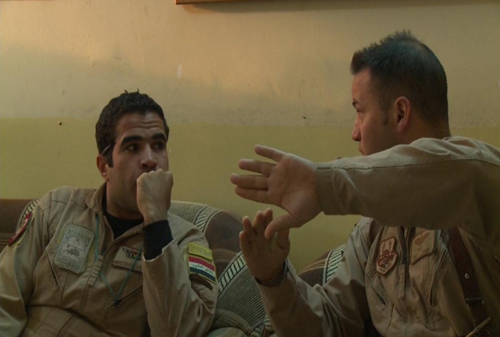 Iraqi gunners look out from above