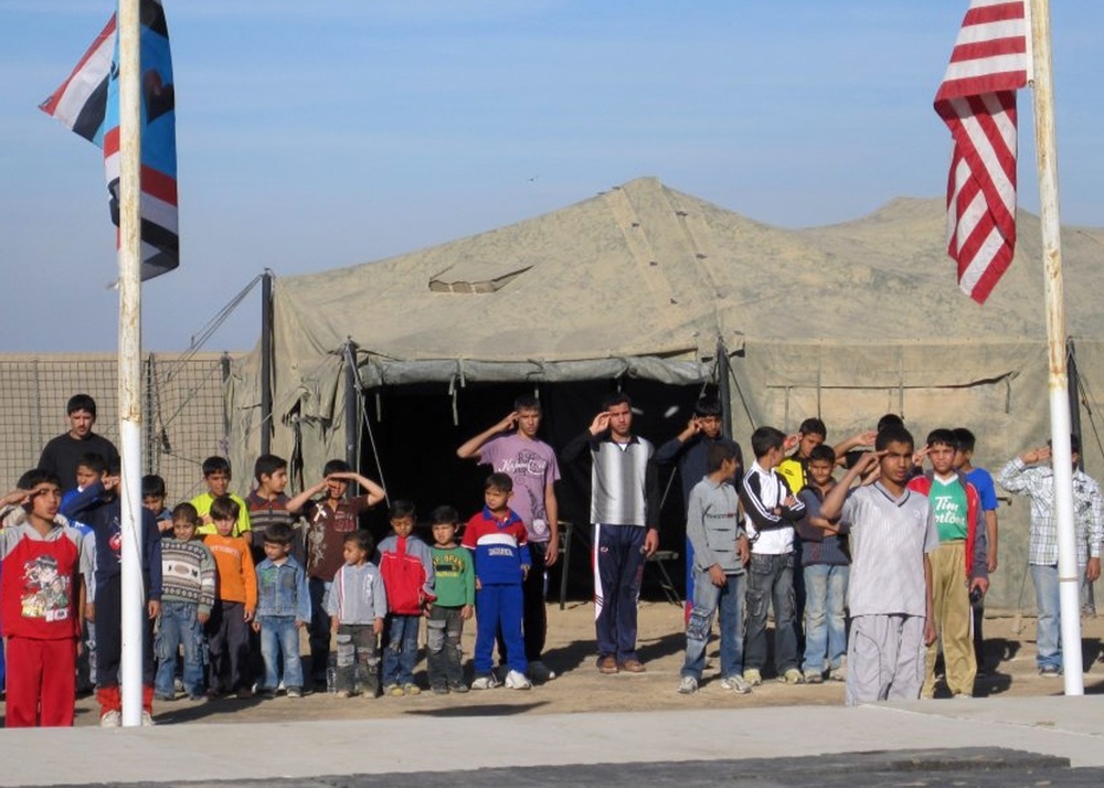 Iraqi Boy Scouts interact with American Forces