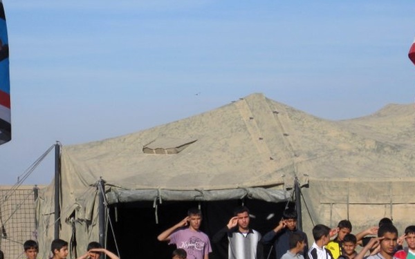 Iraqi Boy Scouts interact with American Forces
