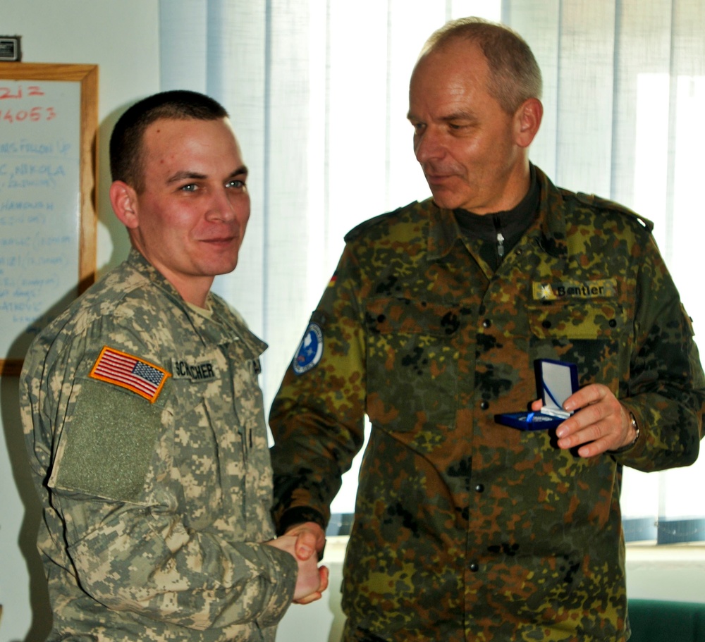 Kosovo Forces commander receives briefing from Multi-National Battle Group - East Liaison and Monitoring Team