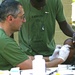 A medical doctor with the Spanish Marines renders medical aid to a Haitian Boy