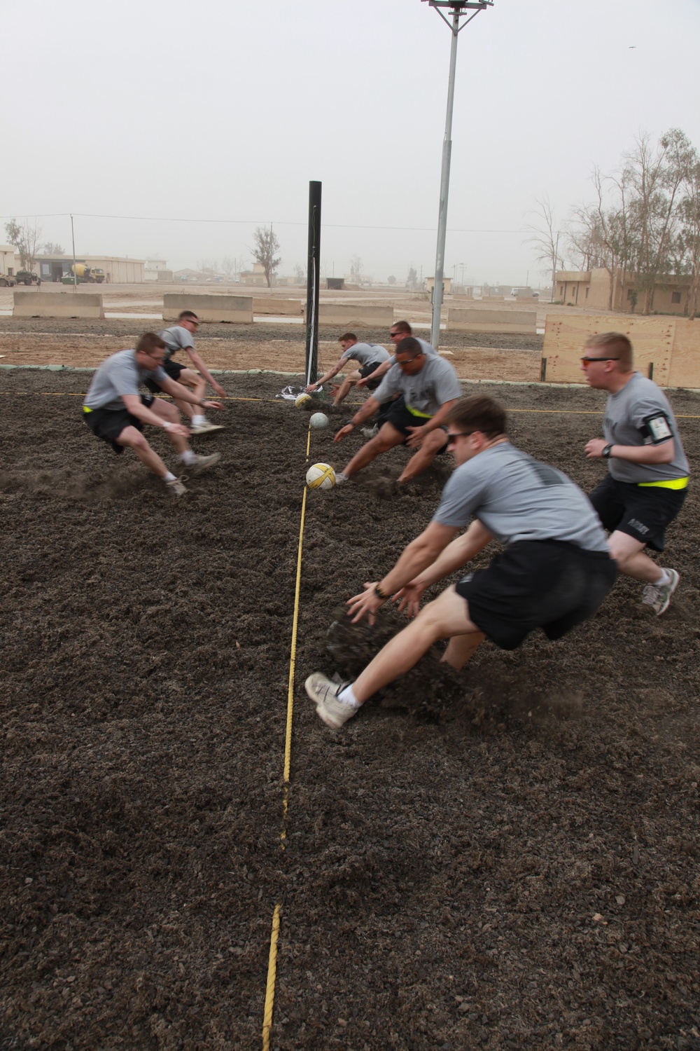 U.S. Soldiers from 2-23 Infantry Regiment play a volleyball game on Camp Taji