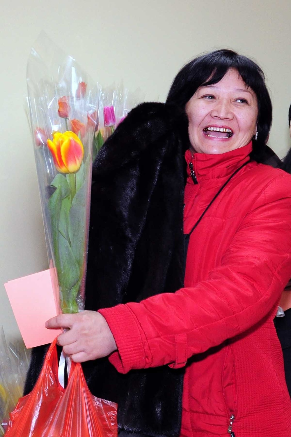 100th woman arriving on Transit Center receives mink coat