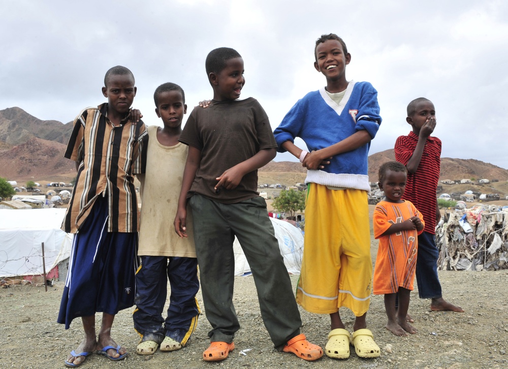 Camp Personnel Help Distribute Shoes to Refugees in Djibouti